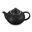 Angled close-up of matte black teapot showing spout, lid and handle