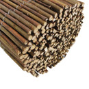 Detailed view of rolled willow fence screening showing cut wooden ends and natural rustic timber finish