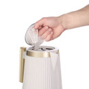 Removable limescale filter being lifted from a cream Russell Hobbs Bronte kettle.