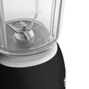 Close-up of the blender jug interior showing the stainless steel four-blade assembly and graduated measurement markings for accurate ingredient preparation.