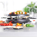 Side view of the Giles & Posner raclette grill loaded with colourful vegetable skewers and ingredients for entertaining.