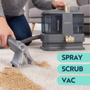 Beldray spot cleaner in use on a carpet stain, combining spray, scrub and vacuum functions for deep cleaning.