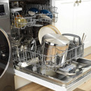 Russell Hobbs stainless steel stockpot and glass lid placed inside a dishwasher, demonstrating dishwasher-safe convenience.