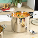 Russell Hobbs 26cm stockpot with polished stainless steel finish, filled with soup and displayed on a kitchen worktop.