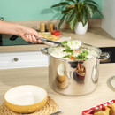 Russell Hobbs stainless steel stockpot filled with rice and vegetables, being served with a large spoon in a modern kitchen.