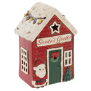 Festive ceramic Santa’s Grotto ornament featuring a red cabin with a snow-covered roof, Christmas lights, wreath-decorated door and Santa Claus figure, displayed on a white background.