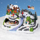 Christmas village display with illuminated cottage, animated Santa and reindeer, colour-changing waterfall, snowman scene and detailed snowy landscape with LED lighting.