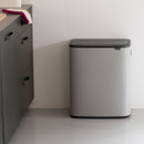 Brabantia Bo Touch Bin 60L in Mineral Concrete Grey positioned in a modern kitchen, featuring a compact floor-standing design with soft-touch lid.