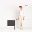 Size comparison image of the Brabantia Bo Touch Bin Hi next to an adult woman, highlighting its 68 cm height and compact footprint.