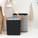Removable inner bucket from the Brabantia Touch Bin 60L being fitted with a fresh bin liner for easy cleaning and maintenance.