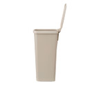 Side view of the soft beige Brabantia StepUp pedal bin with the lid open, showing the compact profile.
