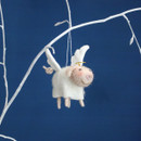 Needle felt angel pig Christmas tree decoration with white wings and a gold halo hanging from a white branch.