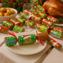 The Grinch Christmas crackers arranged on a festive dining table alongside a roast dinner, potatoes and table settings, featuring colourful Grinch-themed designs.