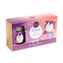 Elysium Spa Sleep Gift Set in Lavender & Amber fragrance, presented in a pink and purple gift box with gold accents. The set includes a scented candle, bath salts and a lavender-coloured bath bomb, visible through cut-out display windows on the packaging.