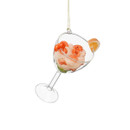 Glass shrimp cocktail Christmas tree decoration in a cocktail glass, topped with prawns and a lemon wedge.