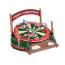 Christmas carnival ride ornament featuring a rotating teacup carousel, miniature festive characters, decorative railings, and a "Merry Christmas" archway.