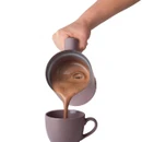 Salter Chocolatier hot chocolate maker pouring freshly frothed hot chocolate into a matching pink mug.