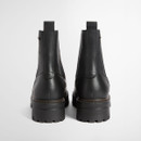 Rear view of black leather Chelsea boots with pull tabs and chunky lug soles.