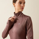 Close-up of the twilight mauve Ariat half-zip pullover featuring a stand collar, quarter-zip closure, thumbholes, and a tonal Ariat logo on the chest.
