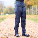 Women's navy waterproof riding chaps with full-length side zips, adjustable waist belt, elasticated stirrups and reinforced lower leg panels for reliable wet-weather protection over breeches.