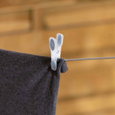 Betterware PVC core clothes line supporting a garment with a peg, demonstrating secure outdoor clothes drying.