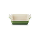 Rectangular stoneware baking dish in a bamboo green finish with integrated side handles, shown from a front angle.