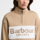 Close-up of the Barbour women's beige quarter zip sweatshirt highlighting the embroidered Barbour EST.1894 logo, contrast chest panel and high funnel neck.
