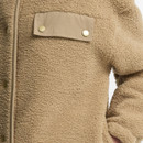 Close-up of camel teddy fleece jacket showing textured borg fabric, contrast chest pocket flap and gold-tone press studs.