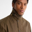 Close-up of the Barbour Icons Beaufort men's beech wax jacket featuring the storm collar, brass press studs and weatherproof waxed cotton fabric.