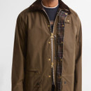 Close-up of the Barbour Icons Beaufort men's beech wax jacket showing the tartan lining, corduroy collar, concealed zip and press stud fastening.