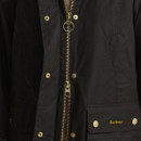 Close-up of the Barbour Icons Beadnell olive wax jacket showing the two-way zip, brass press studs and signature Barbour branding.