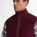 Close-up of the Barbour Langdale men's dark burgundy fleece gilet featuring a funnel neck, full zip fastening and contrast shoulder trim.