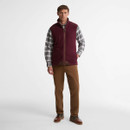 Barbour Langdale men's dark burgundy fleece gilet styled over a checked shirt with chinos for a smart casual country look.