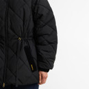 Close-up of the Barbour women's black quilted jacket showing the oversized patch pocket, elasticated cuff and adjustable drawstring waist.