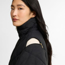 Close-up of the Barbour women's black quilted jacket featuring a detachable zip-off sleeve, funnel neck and diamond quilting.