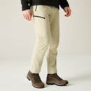 Model wearing brown waterproof mid-cut hiking boots with cream outdoor trousers, showcasing supportive fit, lace-up fastening and all-terrain rubber soles for outdoor adventures.