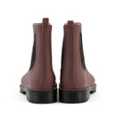 Rear view of a pair of burgundy waterproof Chelsea wellington boots showing heel pull tabs, black elastic gussets and sturdy lug soles.