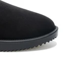 Sole view of a black adjustable slingback mule slipper with a textured wave-pattern outsole for enhanced indoor and outdoor traction.