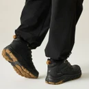 Rear view of black waterproof hiking boots with deep-lug rubber outsole, padded collar and heel pull tabs, designed for hiking and outdoor adventures.