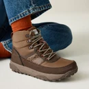 Women's brown waterproof hiking boot worn with blue jeans and rust-coloured socks, showcasing the cushioned ankle collar, leopard-print side detail and rugged outdoor sole.