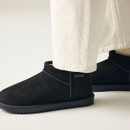 Close-up side view of black waterproof ankle boots featuring faux fur lining, stitched trim, durable rubber sole and Regatta Outdoors branding.