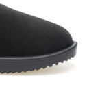 Close-up of the rounded toe and textured black upper of a waterproof ankle boot with stitched edge and rugged sole.