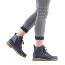 Model wearing navy blue lace-up ankle boots with side zip fastening and durable gum sole.