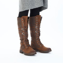 Model wearing Rieker tan knee-high lace-up boots with faux fur lining, lace-up front and rugged outsole.