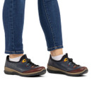 Model wearing Rieker Paz navy and wine comfort shoes with elastic toggle fastening, lightweight flexible soles and everyday casual styling.
