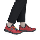 Model wearing Rieker women's red leather slip-on shoes with colourful elastic straps and lightweight flexible soles for everyday comfort.