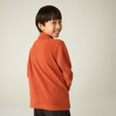 Rear view of child wearing a burnt orange half-zip fleece with a high collar.