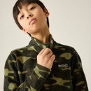 Close-up of child wearing a dark khaki camouflage half-zip fleece with stand collar.