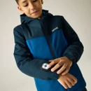 Child demonstrating the integrated LED safety light on the sleeve of a navy and blue waterproof jacket.