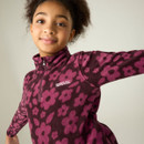 Close-up of child wearing a purple floral printed half-zip fleece with Regatta Outdoors logo.
